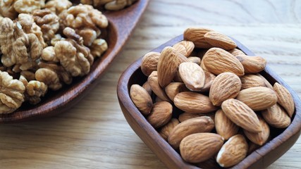 different types of nuts on a wooden dish 