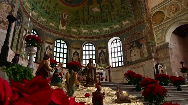 Ravenna, Italy, December 2019. Footage inside the Apollinare basilica in the classroom. Tilt movement from top  to bottom in the direction of the apse. In evidence the saint Apollinare with open arms.