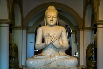 Buddha statue inside of the Sri Dalada Maligawa or the Temple of the Sacred Tooth Relic, a Buddhist temple in the city of Kandy, Sri Lanka. which houses the relic of the tooth of the Buddha.