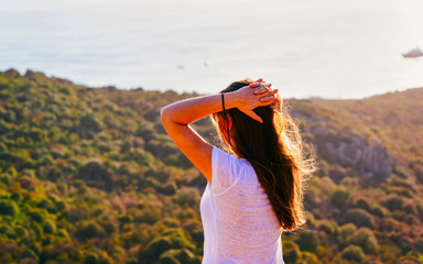 Scenery with girl at Porto Rotondo at sunrise or sunset at Mediterranean Sea on Costa Smeralda. Woman and Porto Cervo in Sardinia Island in Italy in summer. Landscape of Olbia province. Mixed media.