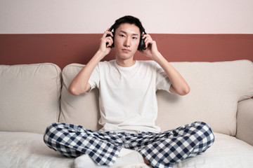 Asian Young Man Listening Music On Headphone, Indoors