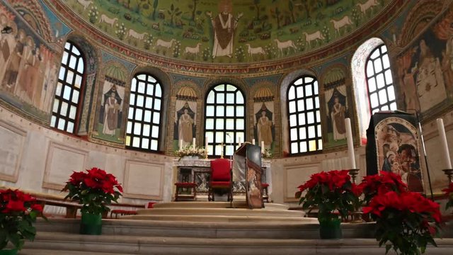 Ravenna, Italy, December 2019. Footage inside the Apollinare basilica in the classroom. Tilt movement from bottom to top in the direction of the apse. In evidence the saint Apollinare with open arms.