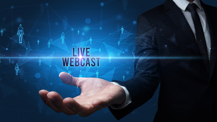 Fototapeta premium Elegant hand holding LIVE WEBCAST inscription, social networking concept