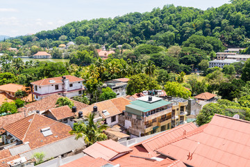 Beautiful builings on the green hills in the downtown, nex to the Kandy Lake or Kiri Muhuda or the Sea of Milk, an artificial lake in the heart of the hill city of Kandy, Sri Lanka