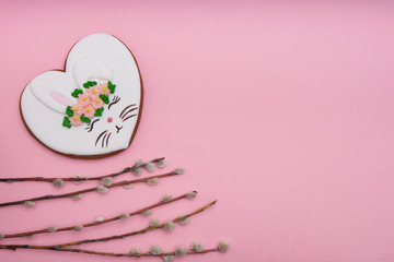 Easter bunny, gingerbread with glaze on pink background Copy space