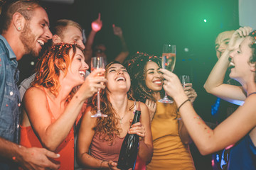 Happy friends doing party drinking champagne in nightclub - Group young people having fun...