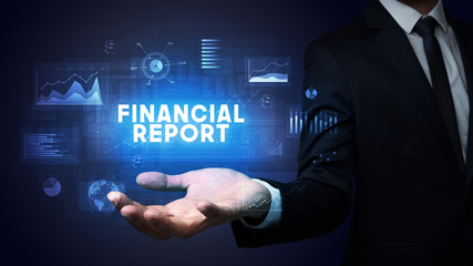 Hand of Businessman holding FINANCIAL REPORT inscription, business success concept