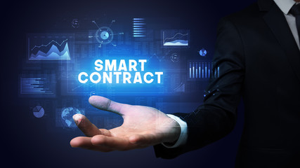 Hand of Businessman holding SMART CONTRACT inscription, business success concept