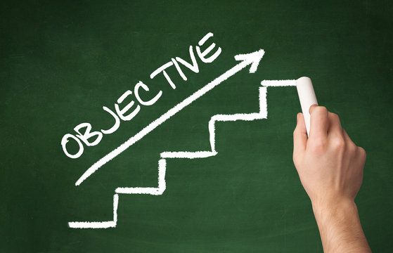 Hand drawing OBJECTIVE inscription with white chalk on blackboard, business concept