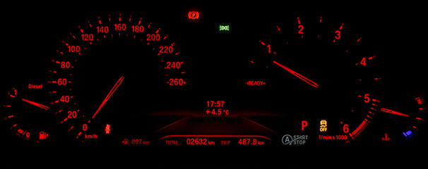 Modern red illuminated instrument cluster with speedometer, tachometer, odometer, fuel and...