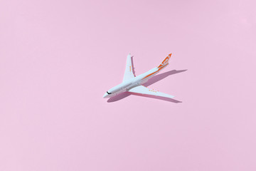 Model plane, airplane on pink color background. Travel concept with plane