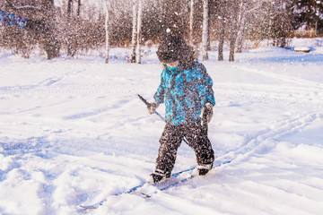 child goes skiing in a snowstorm