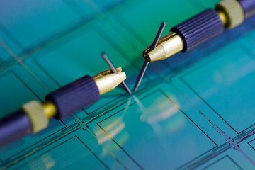 Manual probe system with needles for test of semiconductor on silicon wafer. Selective focus.