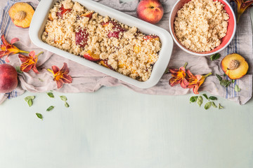 Peach cobbler cooking preparation on light background with fresh peach , top view. Copy space