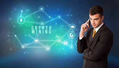 Businessman in front of cloud service icons with CRYPTO MINING inscription, modern technology concept