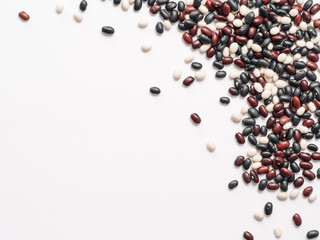 Top view of raw mixed beans on white background. Mixed of uncoocked black, red and white beans with copy space isolated on white. Food background. Vegan protein concept. Flat lay