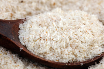 Portion of Psyllium Seeds on rustic dark background. Psyllium seed husks on wood
