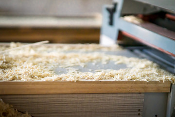 wood saw dust pile at a woodworking workshop.
