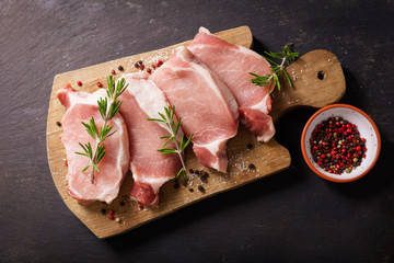 fresh pork chops with rosemary and spices, top view