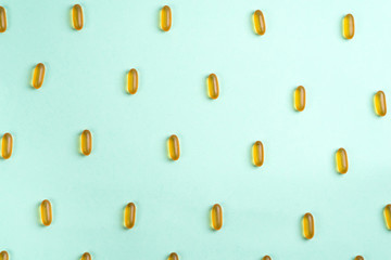 Omega 3 fish oil capsules isolated on a blue background