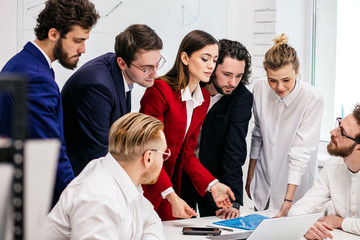 young caucasian good-looking people in formal wear stand next to their female boss or manager in...