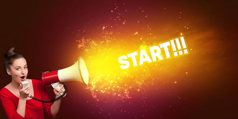 Young woman yelling to loudspeaker with START!!! inscription, modern media concept