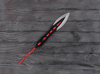 throwing knives on wooden background