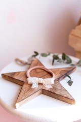 Beautiful fashion accessory for baby girls. Handmade accessories lace and stars on elastic band on white and brown background. Concept of children's clothing.