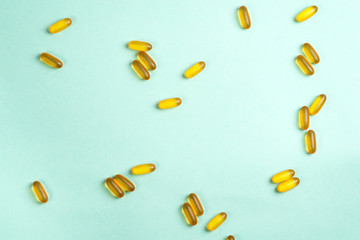 Omega 3 fish oil capsules isolated on a blue background
