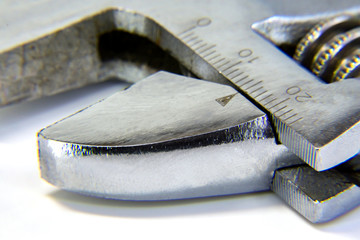 Metal chrome-plated adjustable key in the open form. Adjustment ring with scale. Macro mode. Isolated background. Selective focus.Copy space. A tool for working with it