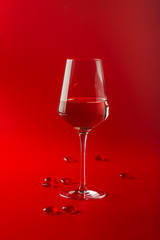 Full glass of wine over red background