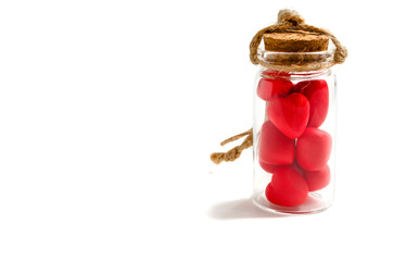 red hearts in a glass bottle with a brown cork and a rope tow on a white background concept valentines day heart thief heartbreaker