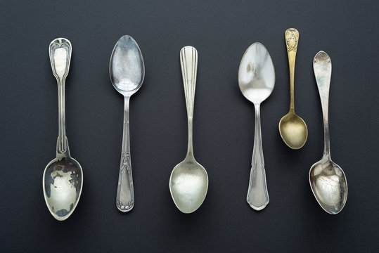 Vintage spoons pattern on black background.
