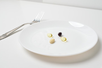 Meal replacement. Multivitamin and mineral supplements.  Table set with tablets. Fish oil, vitamins and astaxantnin.