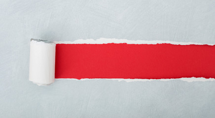 torn gray paper over red background