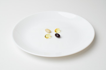 Multivitamin and mineral supplements. Plate with tablets. Meal replacement. Closeup.