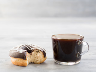 donuts and coffee on gray wooden background , copy space