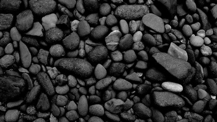 black stone background of pebble beach stones