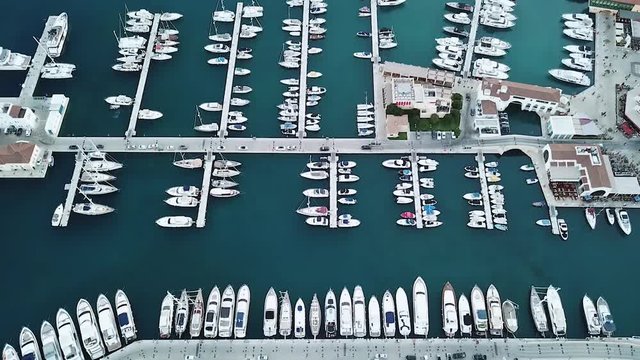 Top down aerial view of Limassol Marina, Cyprus. Luxury yachts and boats docked, drone footage