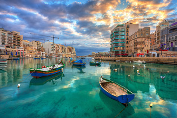 Traditional fishing boats on the Spinola Bay at sunrise, Malta - obrazy, fototapety, plakaty