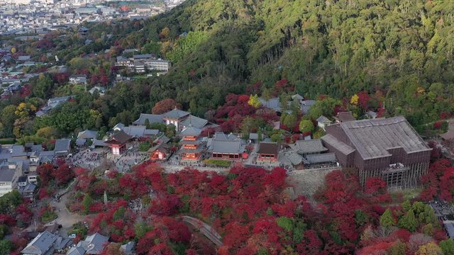 Aerial view of iconic Buddhist temple Kiyomizu-dera in Kyoto City, picturesque autumn scenery with red trees - landscape panorama of Japan from above, Asia
