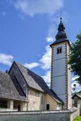 Fototapeta premium Old stone church on the shore of a mountain lake.