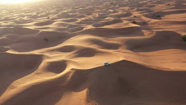 Aerial view of car riding in the desert.