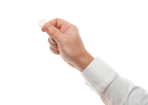 Man hand with one big white pill isolated on white background. White shirt, business style. Medicament and food supplement for health care. Pharmaceutical industry. Pharmacy.