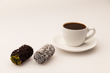 Cup of coffee and cookies on white background