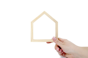 Business women hand holding wooden frame in shape of house on white background. Financial,...