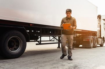 Asian Truck Driver is Checking the Semi Truck's Engine Maintenance Checklist. Lorry Driver....