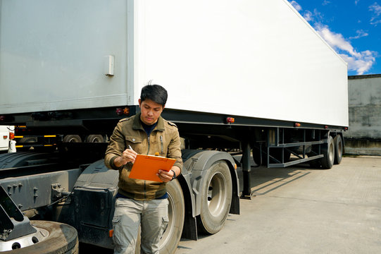 Asian Truck Driver is Checking the Semi Truck's Engine Maintenance Checklist. Lorry Driver. Inspection Truck Safety Driving. Shipping Cargo Freight Truck Transport.	