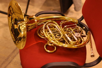 Obraz na płótnie Canvas Tuba brass . brass-wind instrument on a red chair
