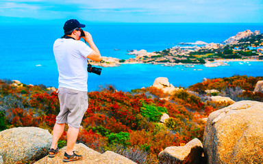 Man and Landscape with Rocky coast of Capo Testa in Santa Teresa Gallura at the Mediterranean Sea...